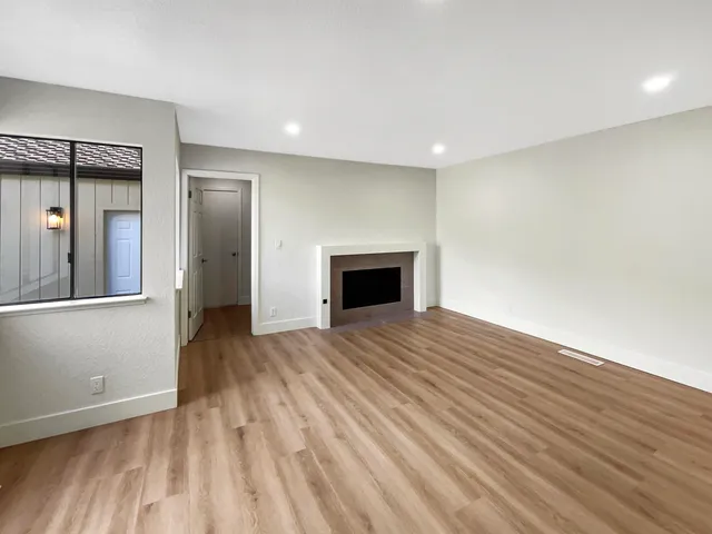 a kitchen with kitchen island granite countertop a stove top oven sink and cabinets