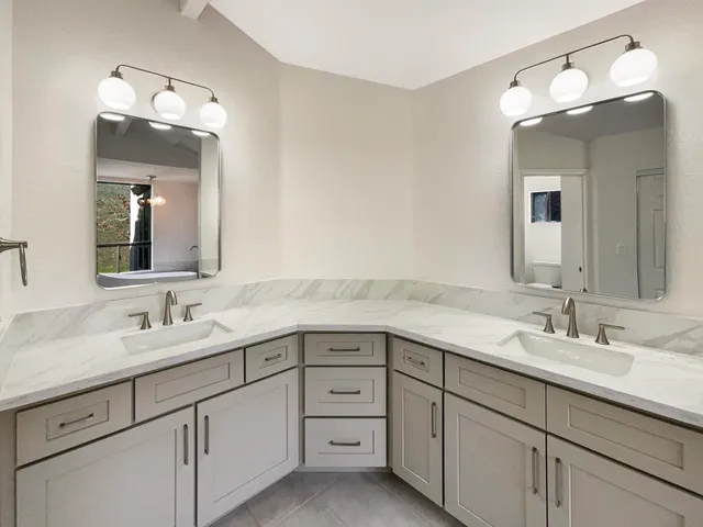 an empty room with windows and bathroom view