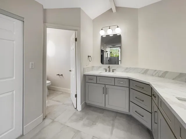 a bathroom with a double vanity sink and mirror