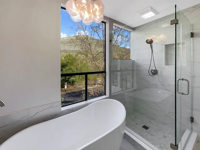 a bathroom with a bathtub and shower