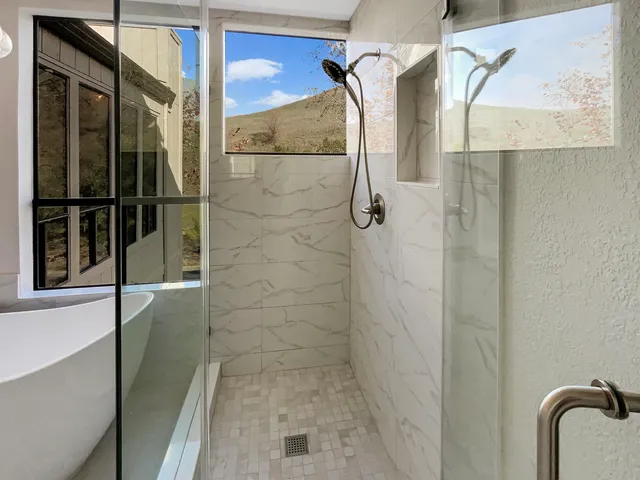 a bathroom with a bathtub and a shower