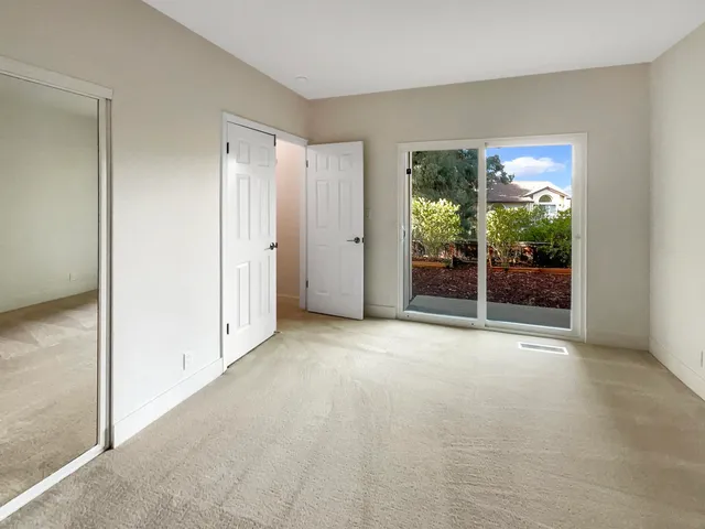 a view of a closet with racks on the wall