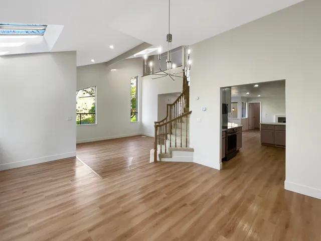 a kitchen with stainless steel appliances a stove a sink a microwave and a refrigerator