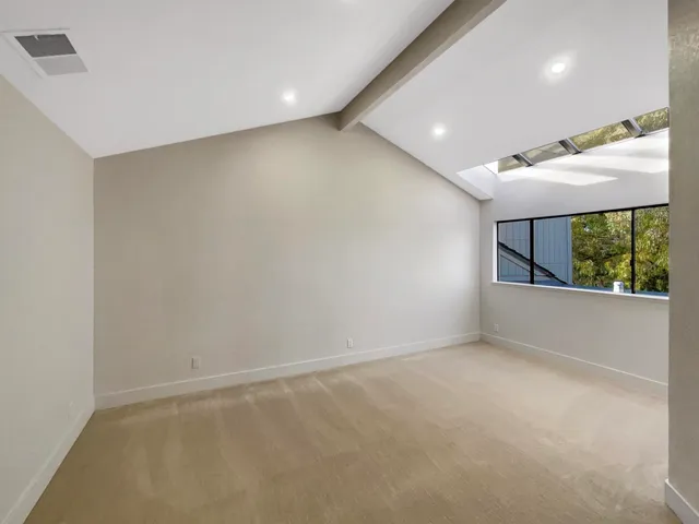 an empty room with windows and outdoor view