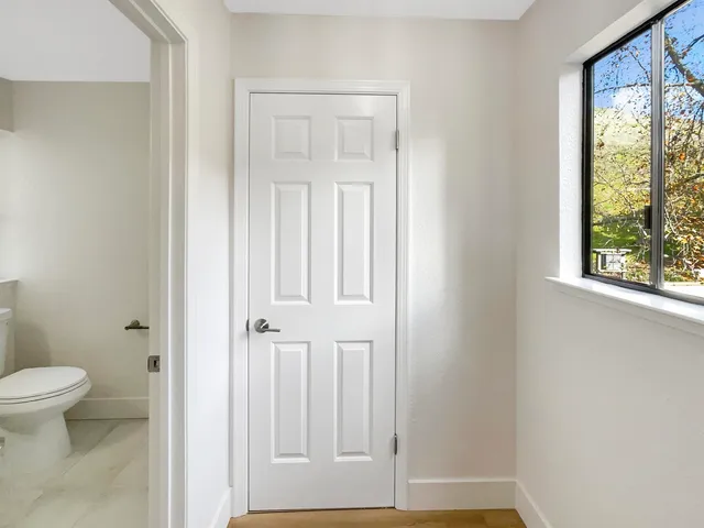 an empty room with windows and closet