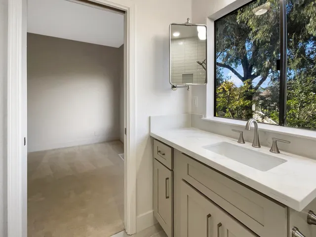 a bathroom with a sink mirror toilet and bathtub