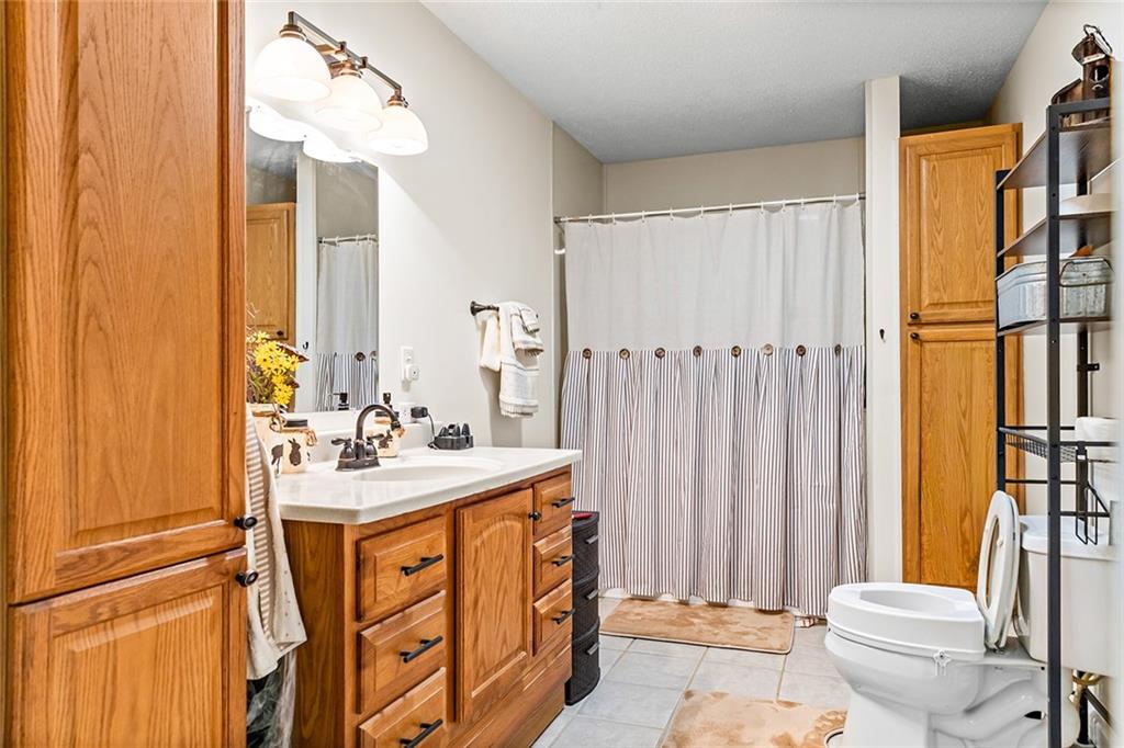 1024 Trail Street Valley, AL 36854 - Photo 19 of 37 Bathroom vanity with integrated sink, bronze-finish faucet, and a wall-mounted mirror