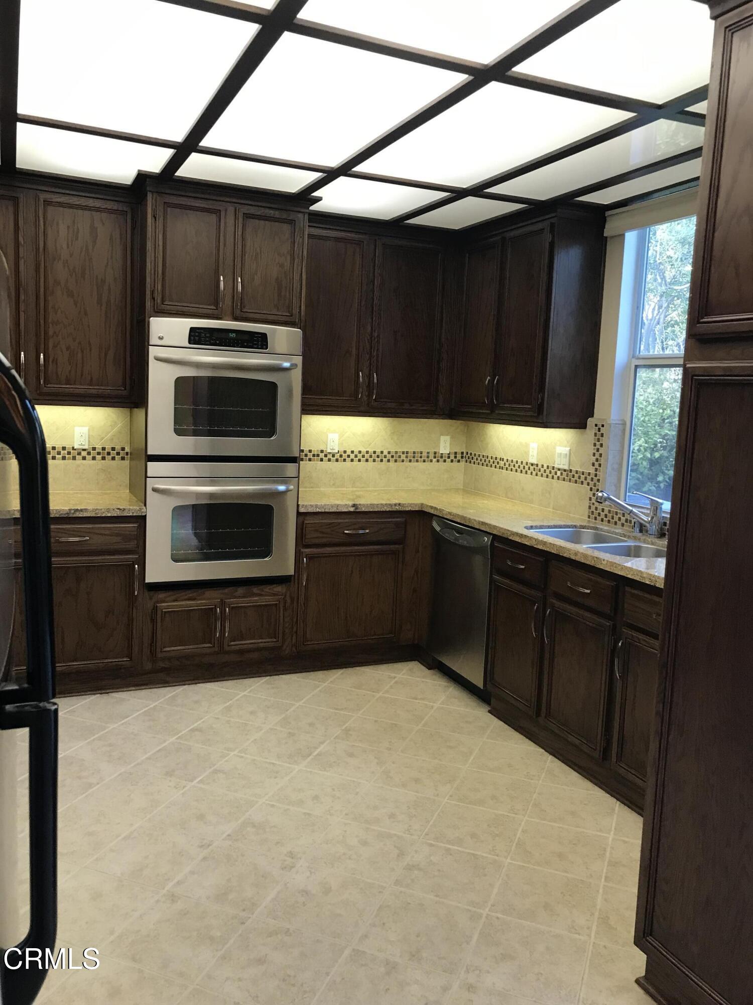 3732 Shelley Place Oxnard, CA 93033 - Photo 12 of 26 a kitchen with stainless steel appliances a stove a sink and a microwave