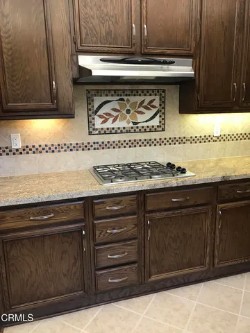 a stove top oven sitting inside of a kitchen