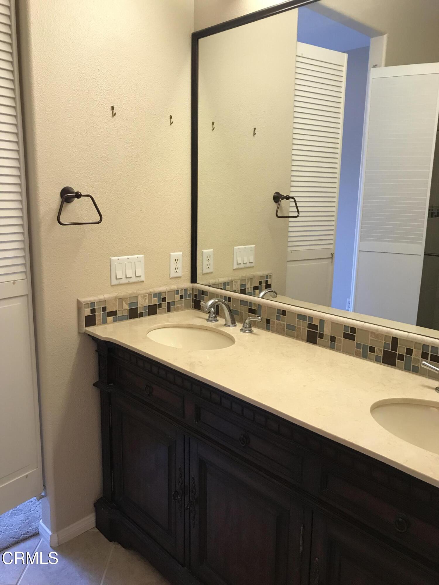3732 Shelley Place Oxnard, CA 93033 - Photo 23 of 26 a bathroom with a double vanity sink and a mirror