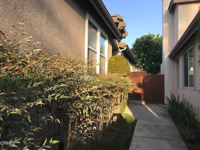 a backyard of a house with table and chairs