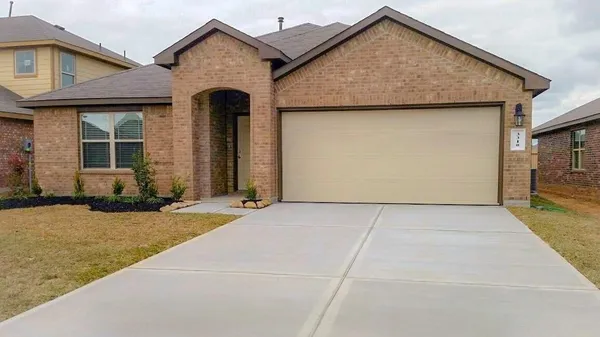 a view of a house with garage and yard