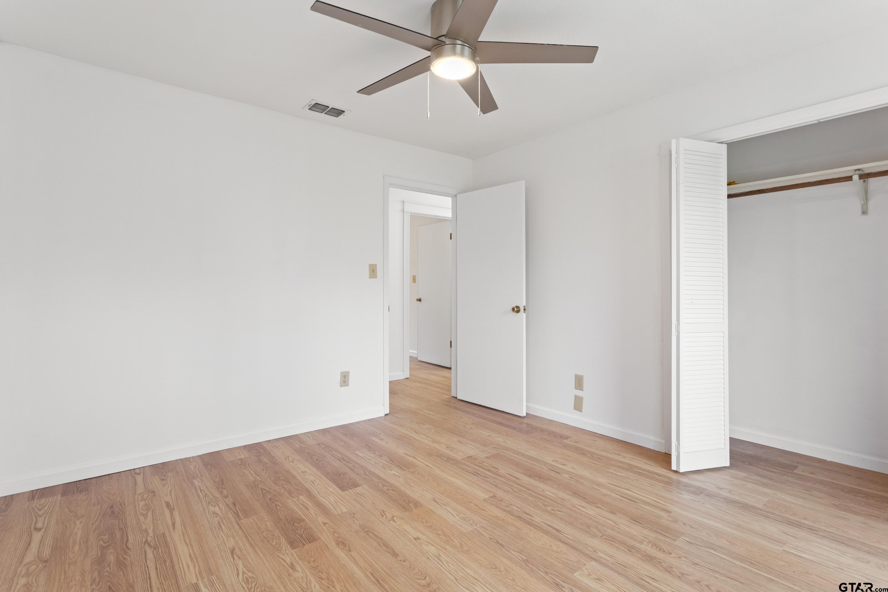 208 Treetop Lane Hideaway, TX 75771 - Photo 19 of 32 wooden floor in an empty room