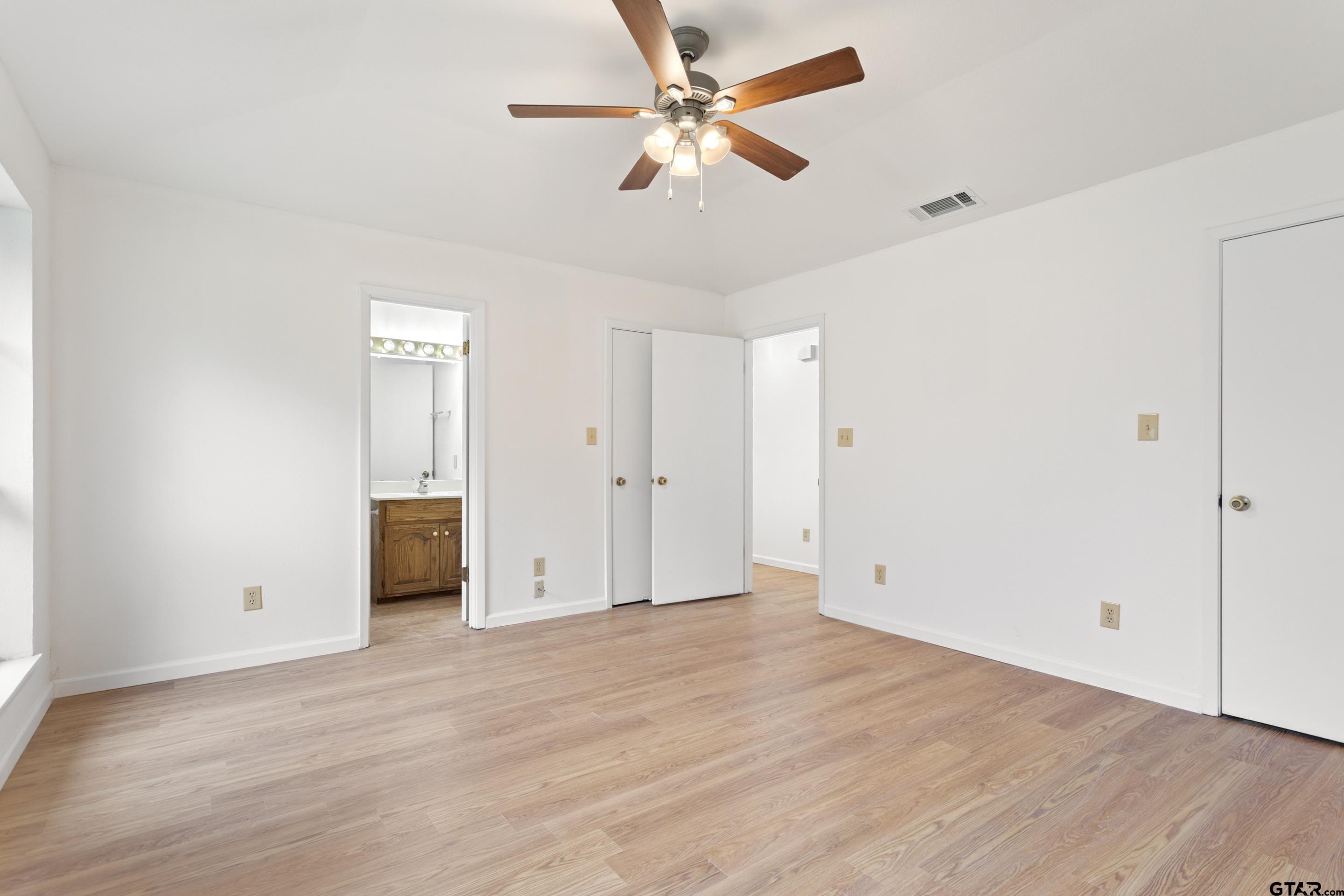 208 Treetop Lane Hideaway, TX 75771 - Photo 20 of 32 an empty room with fan and a ceiling fan