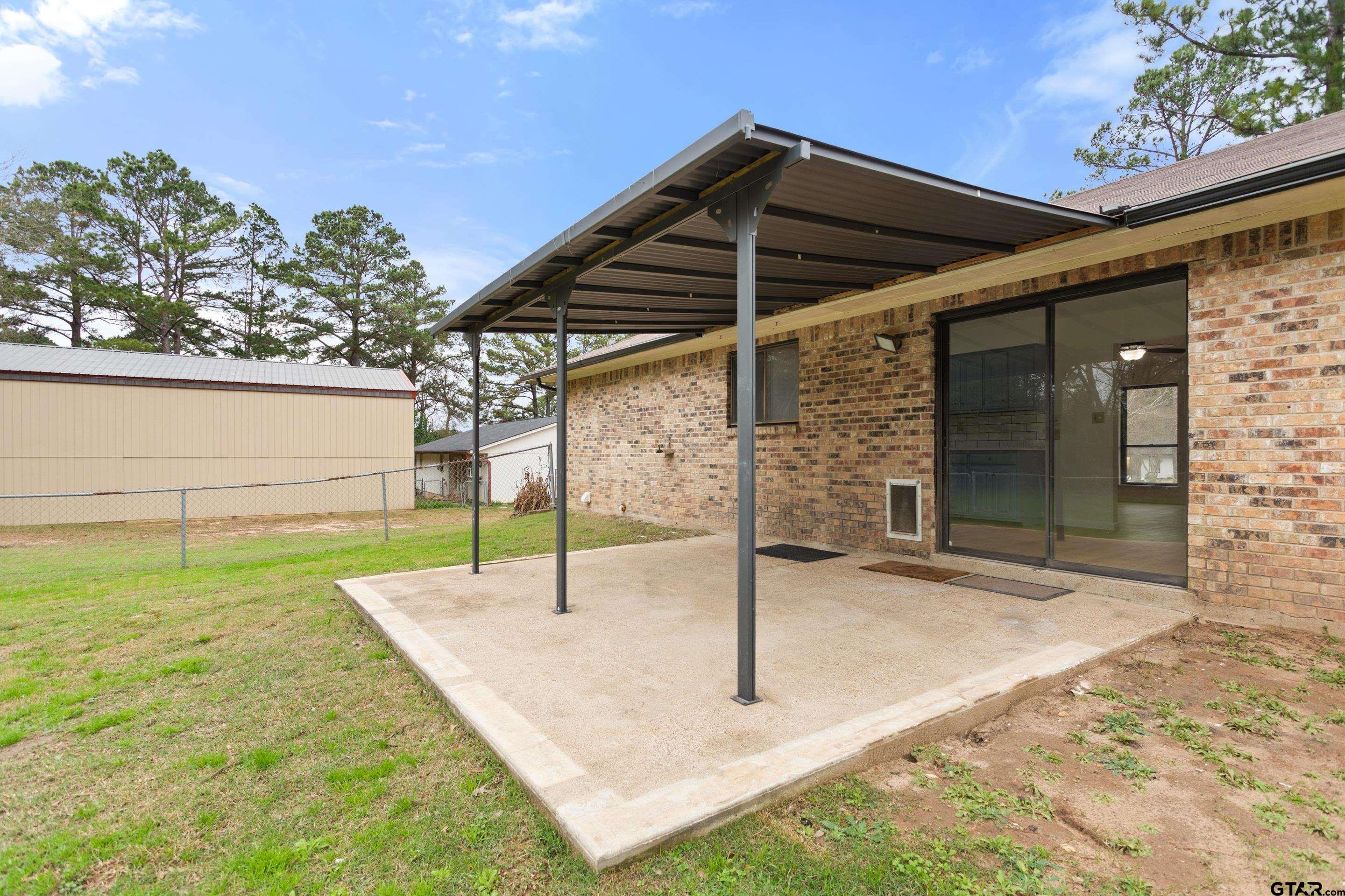 208 Treetop Lane Hideaway, TX 75771 - Photo 27 of 32 a backyard of a house with seating space