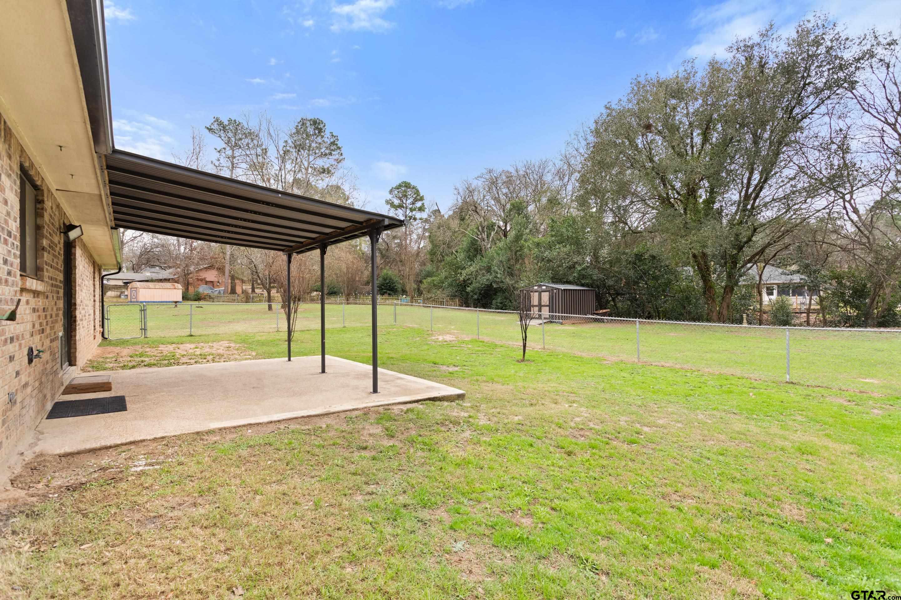 208 Treetop Lane Hideaway, TX 75771 - Photo 28 of 32 a house view with a garden space