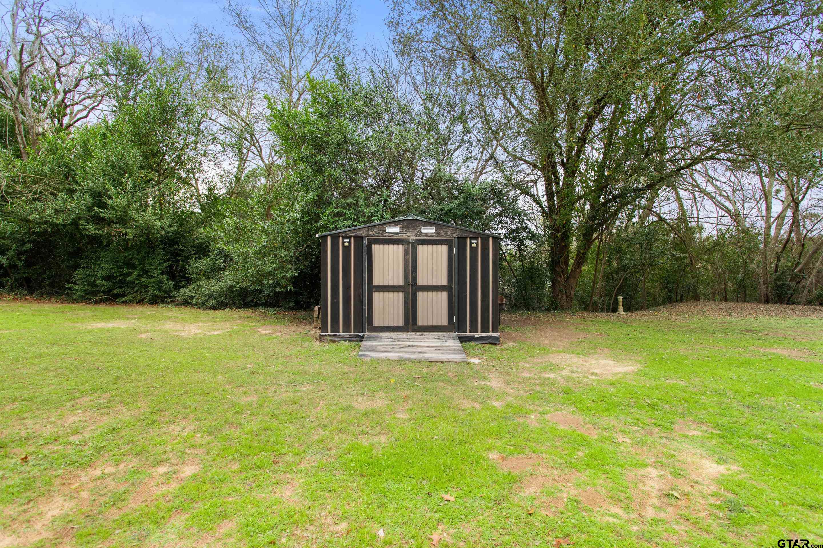 208 Treetop Lane Hideaway, TX 75771 - Photo 30 of 32 a swimming pool with trees in the background