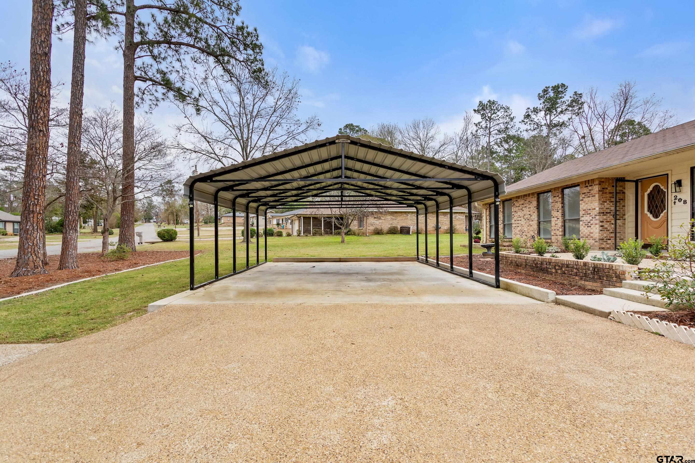 208 Treetop Lane Hideaway, TX 75771 - Photo 3 of 32 a view of a house with a yard and potted plants