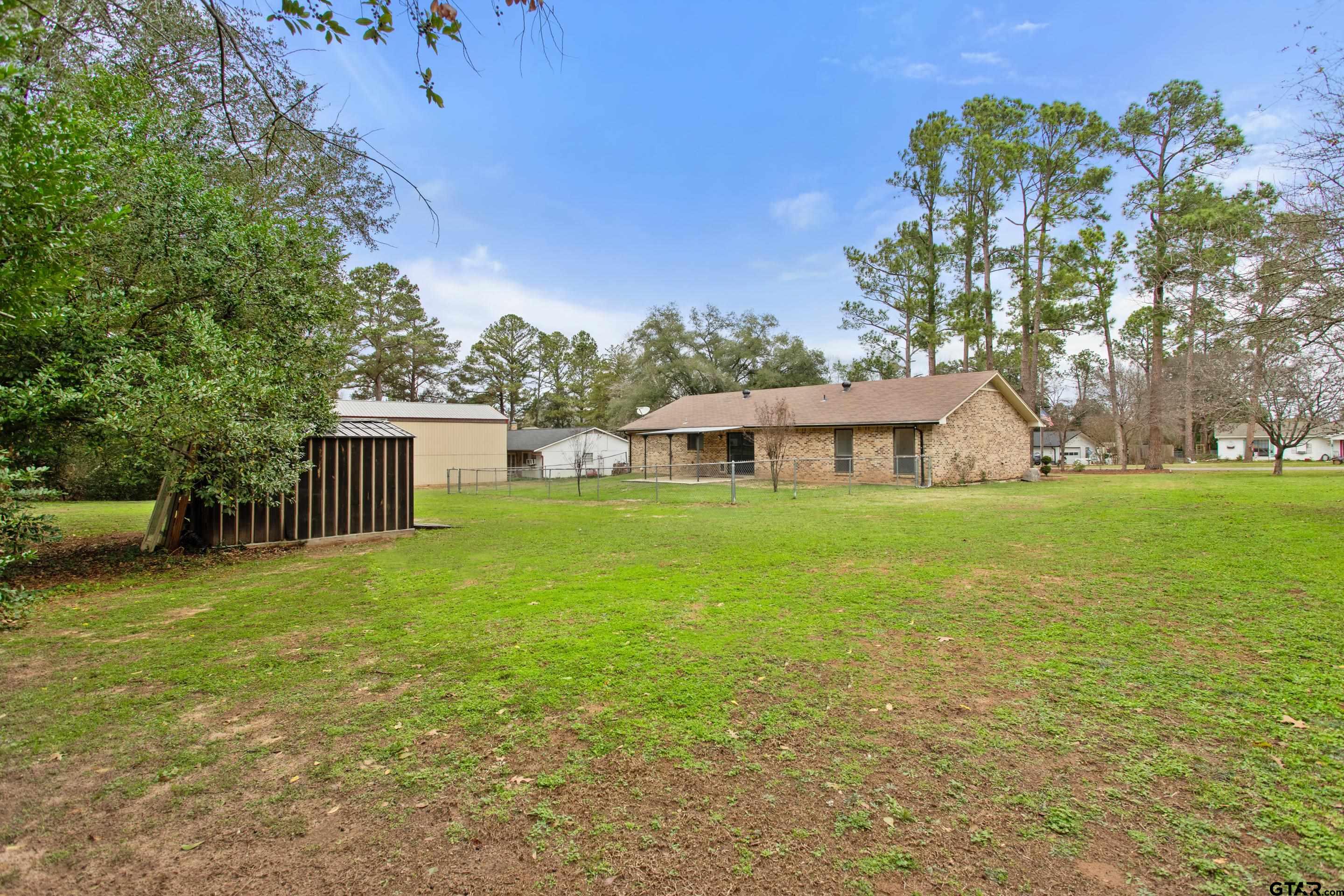 208 Treetop Lane Hideaway, TX 75771 - Photo 31 of 32 a front view of house with yard and trees in the background
