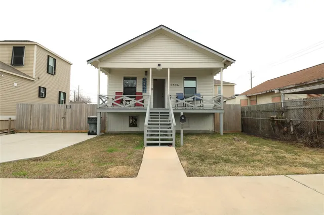 a view of a house with backyard porch and sitting area