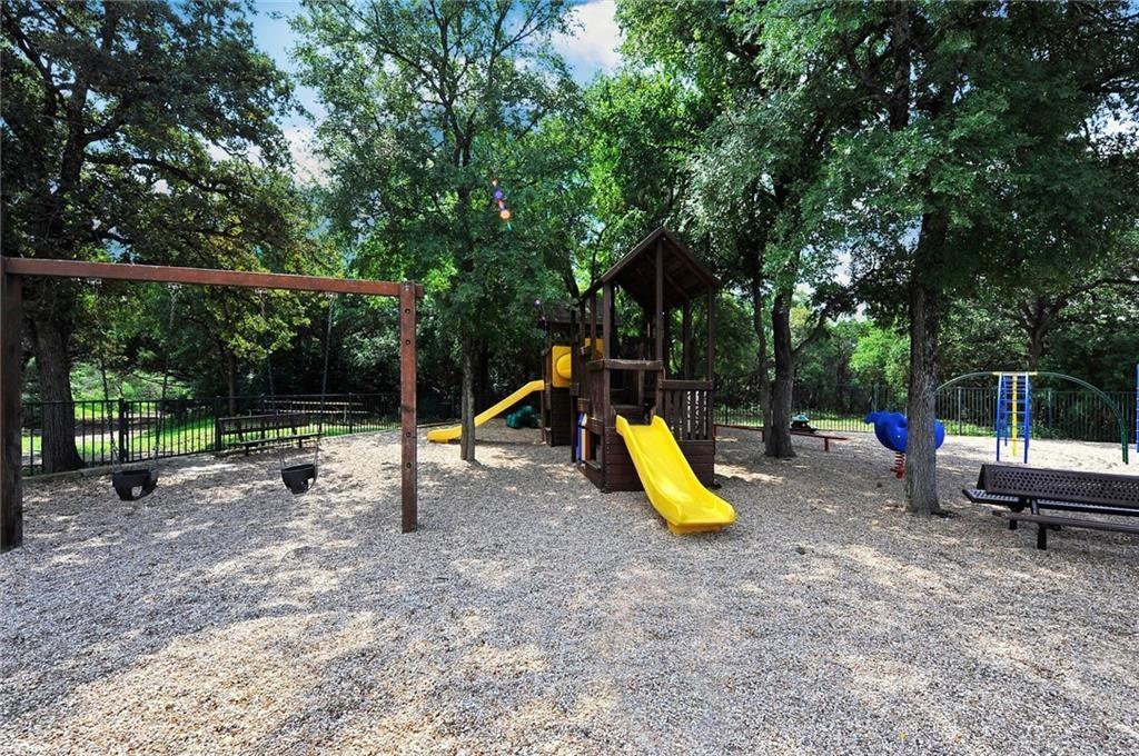 4404 Travis Country Circle, Unit G4 Austin, TX 78735 - Photo 11 of 15 A community playground, shaded by mature trees, provides ample space for children's activities and enjoyment.