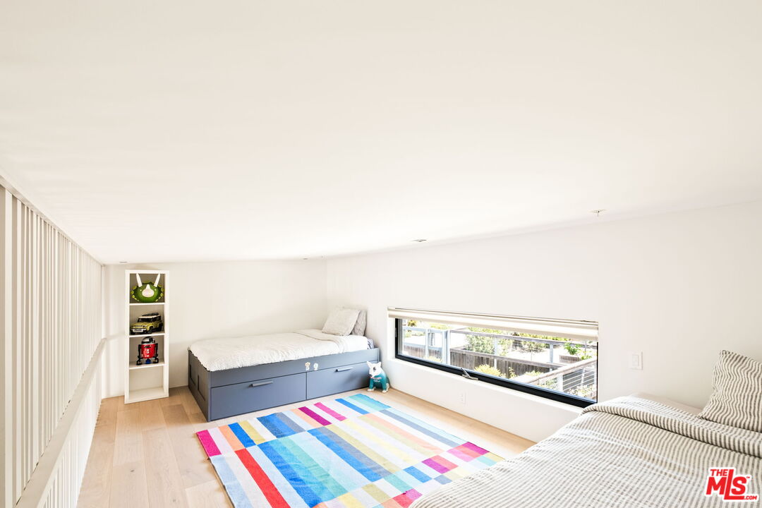 6755 Dume Drive, Unit GH Malibu, CA 90265 - Photo 26 of 31 a bedroom with a bed and a couch