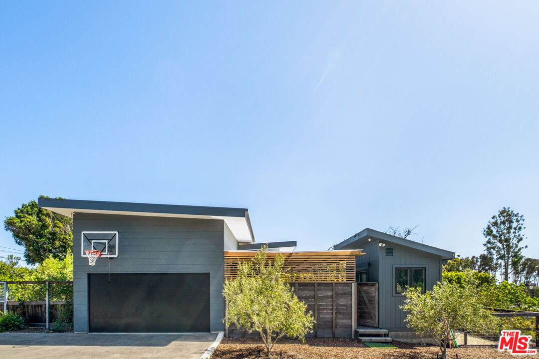6755 Dume Drive, Unit GH Malibu, CA 90265 - Photo 30 of 31 a front view of house with yard