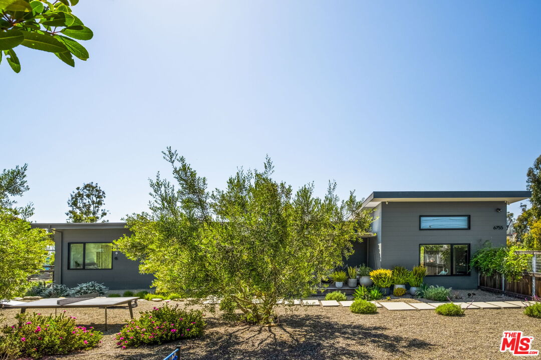 6755 Dume Drive, Unit GH Malibu, CA 90265 - Photo 3 of 31 a front view of a house with a yard