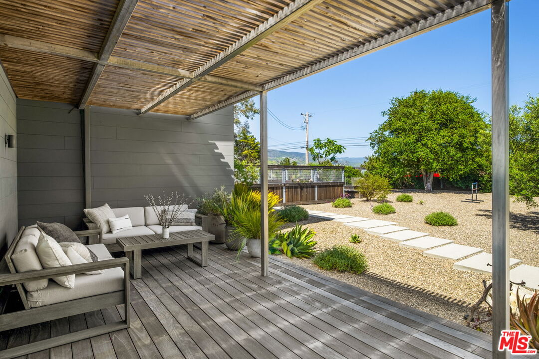 6755 Dume Drive, Unit GH Malibu, CA 90265 - Photo 5 of 31 a view of a patio with couches and chairs with wooden floor and fence