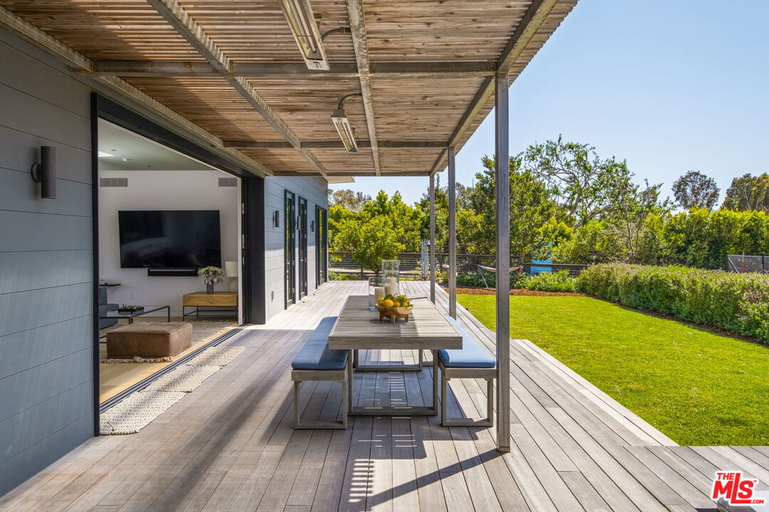 6755 Dume Drive, Unit GH Malibu, CA 90265 - Photo 9 of 31 a swimming pool with outdoor seating and yard