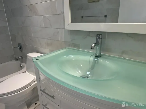 a bath room with a toilet and a bath tub