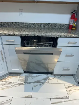 a kitchen with granite countertop a sink and cabinets