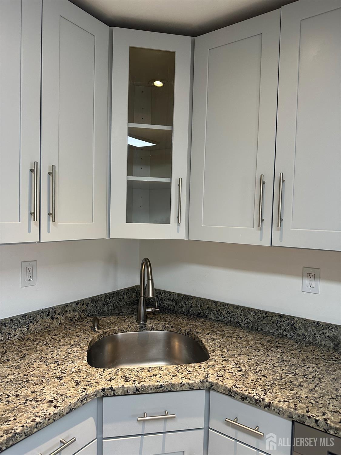 402 Rittenhouse Court North Brunswick, NJ 08902 - Photo 9 of 28 a kitchen with granite countertop a sink and cabinets