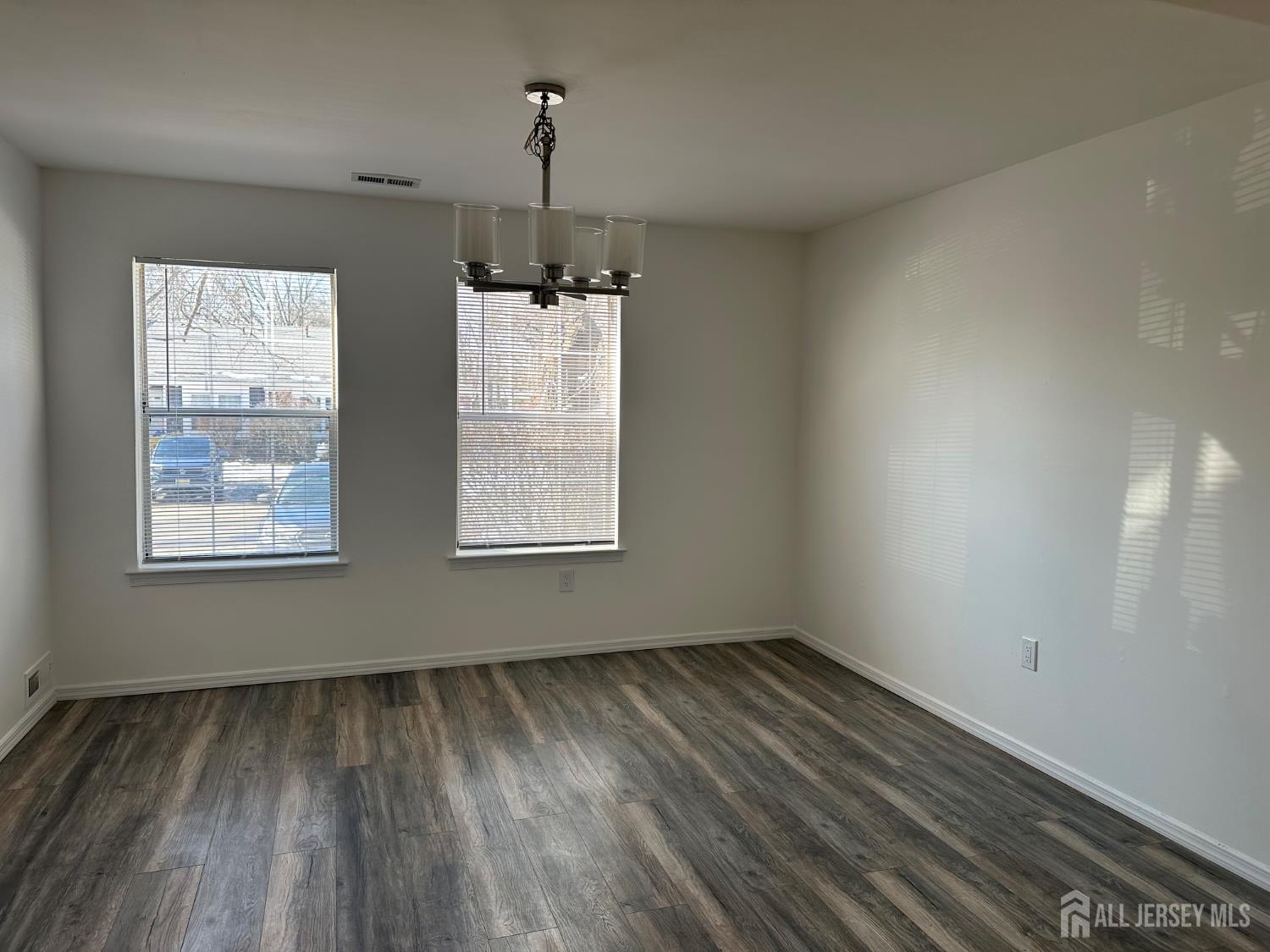 402 Rittenhouse Court North Brunswick, NJ 08902 - Photo 10 of 28 wooden floor in an empty room with a window