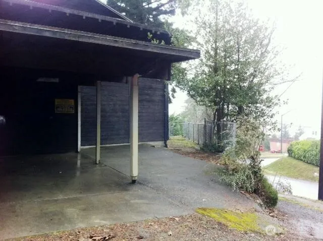 a view of a barn with wooden fence