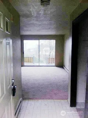 a view of an empty room with a window