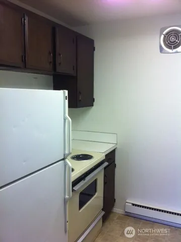 a kitchen with a stove and a refrigerator