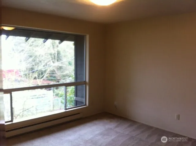 a view of a big room with wooden floor and doors