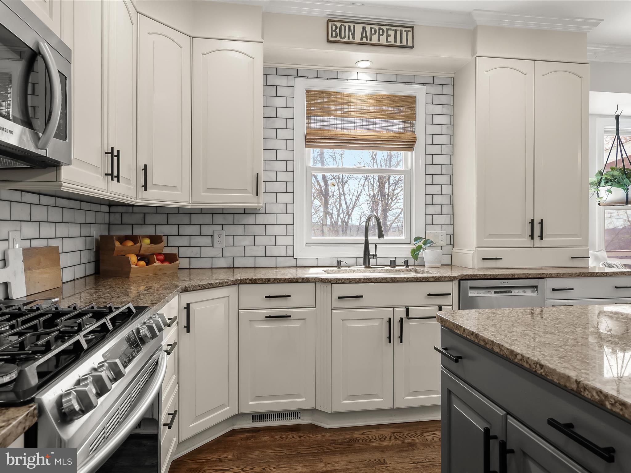 118 Graystone Farm Road White Hall, MD 21161 - Photo 17 of 109 a kitchen with granite countertop a sink stainless steel appliances wooden floor and a counter top space