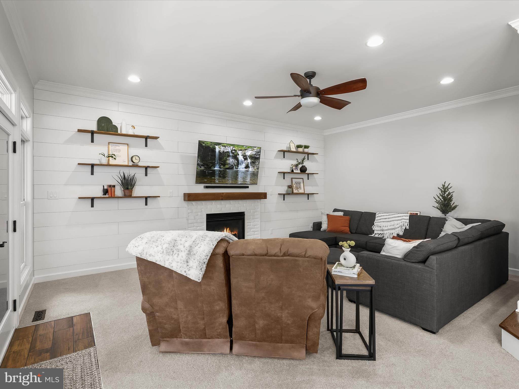 118 Graystone Farm Road White Hall, MD 21161 - Photo 28 of 109 a living room with furniture a fireplace and a flat screen tv