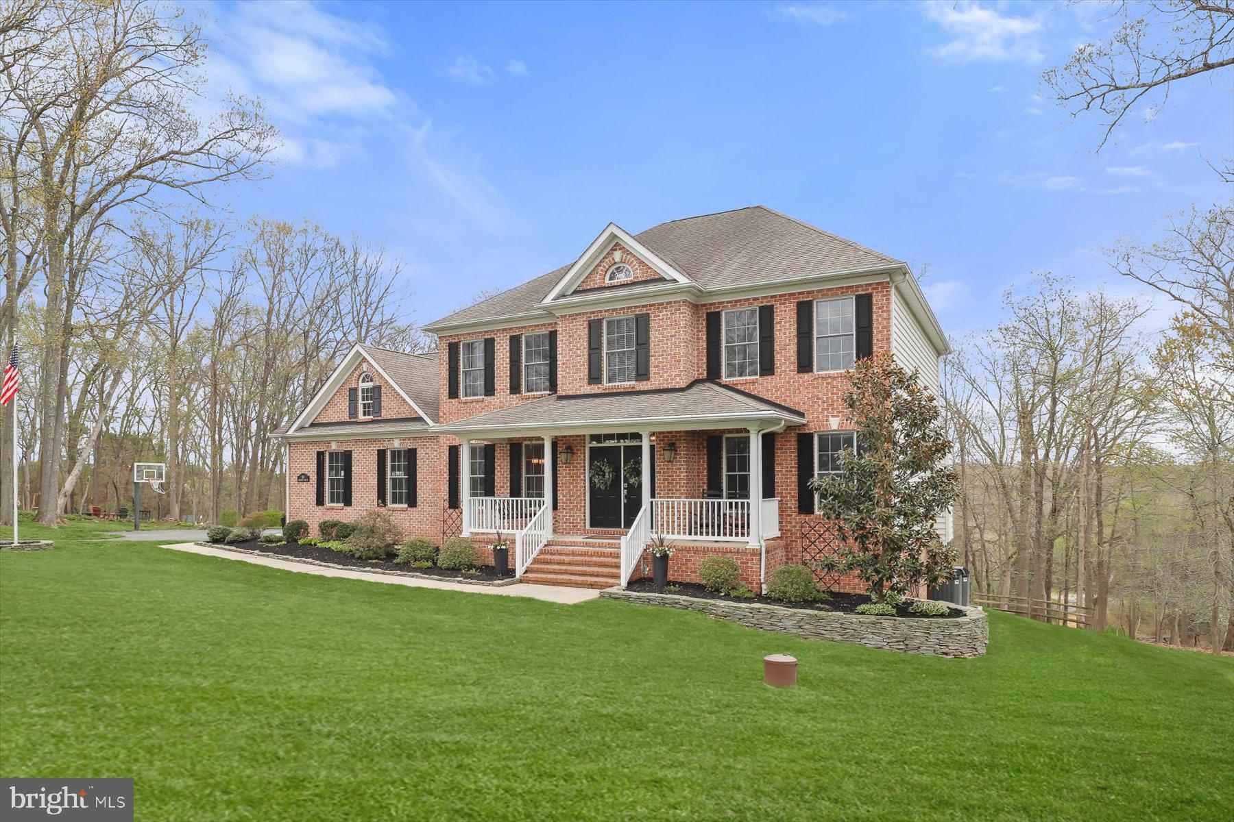 118 Graystone Farm Road White Hall, MD 21161 - Photo 89 of 109 a front view of a house with a garden and trees