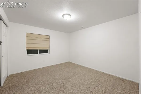an empty room with closet area