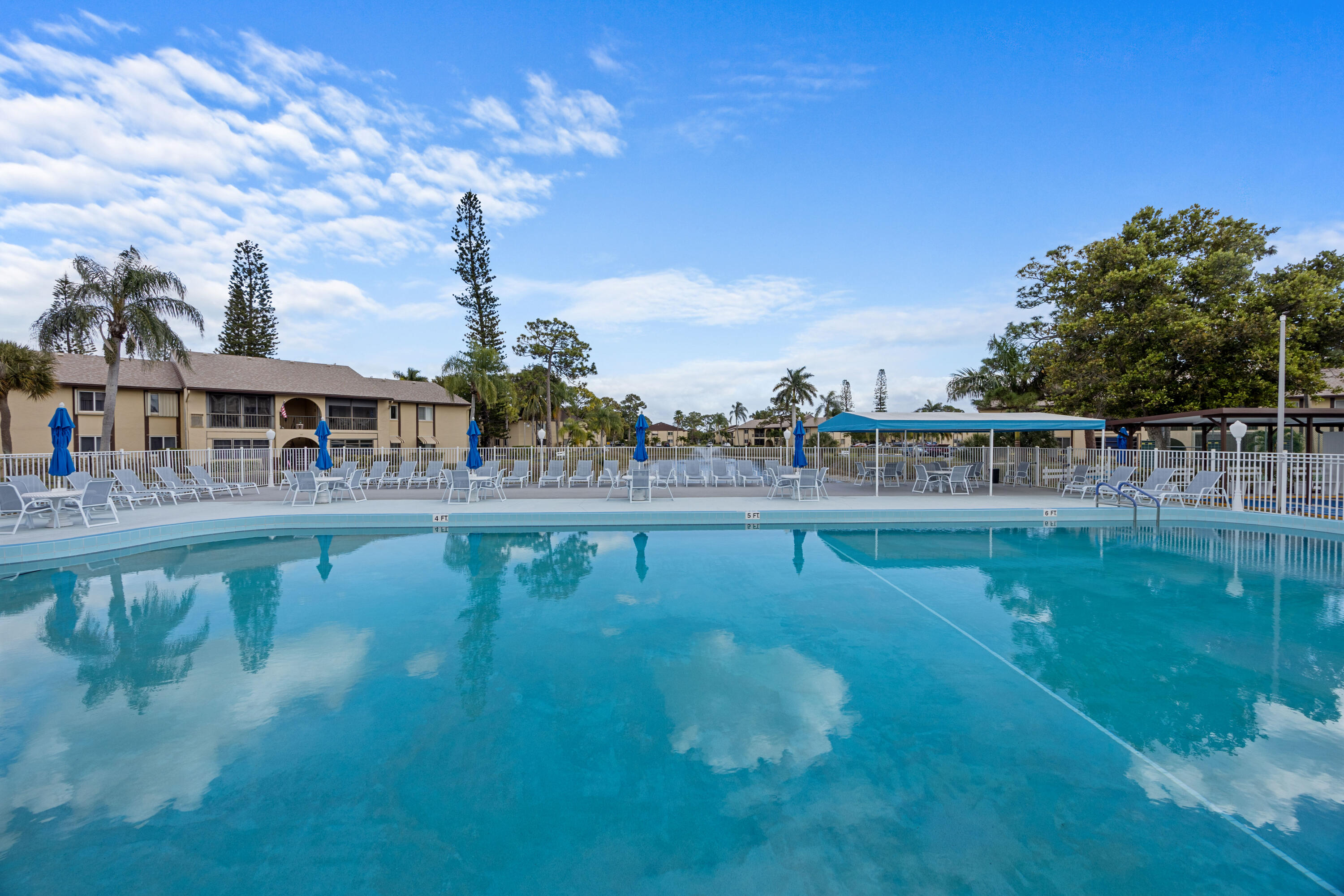 306 Pine Ridge Circle, Unit B2 Greenacres, FL 33463 - Photo 14 of 15 a view of swimming pool with outdoor seating and hardwood
