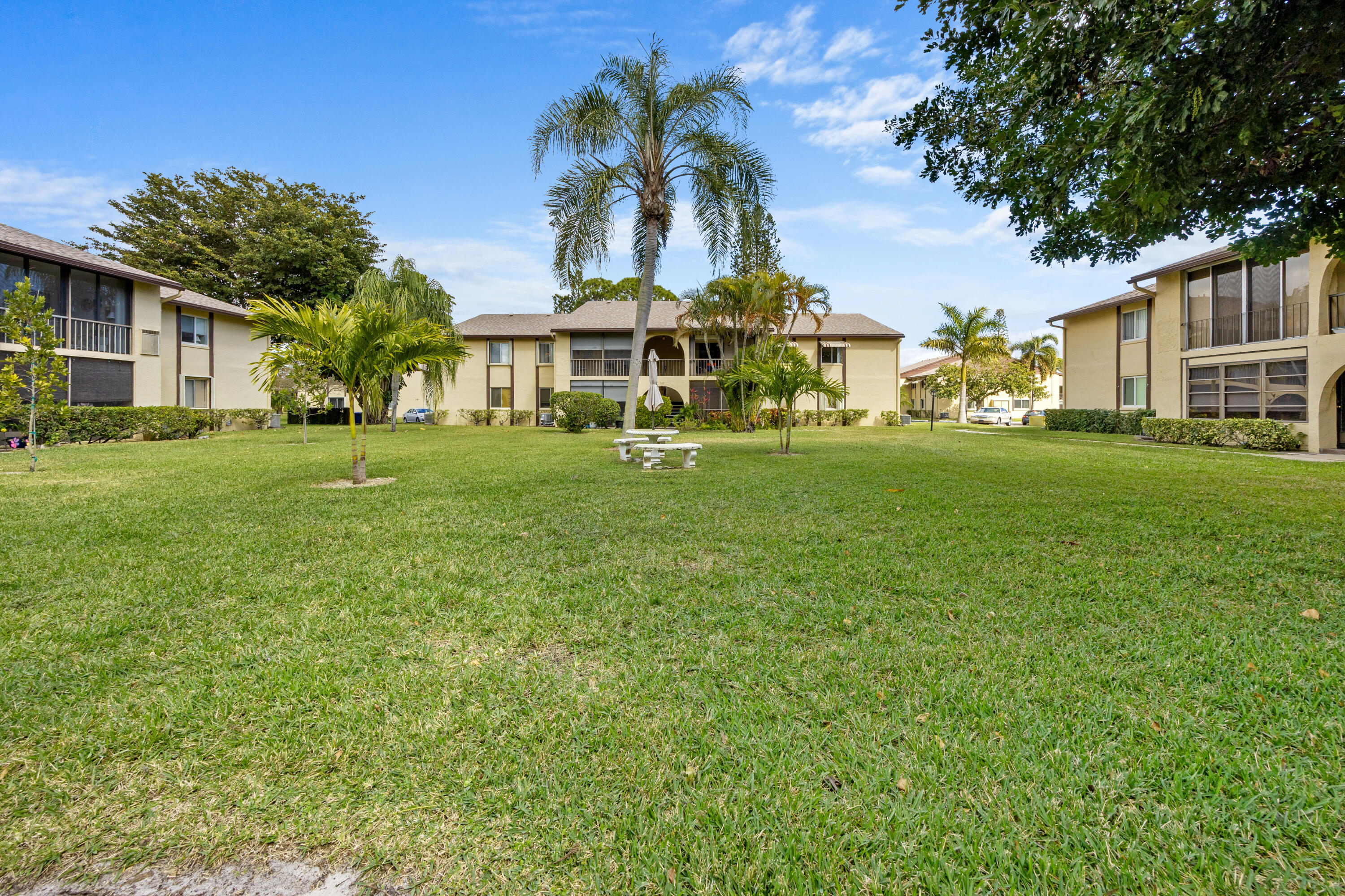 306 Pine Ridge Circle, Unit B2 Greenacres, FL 33463 - Photo 3 of 15 a view of a big yard with a house