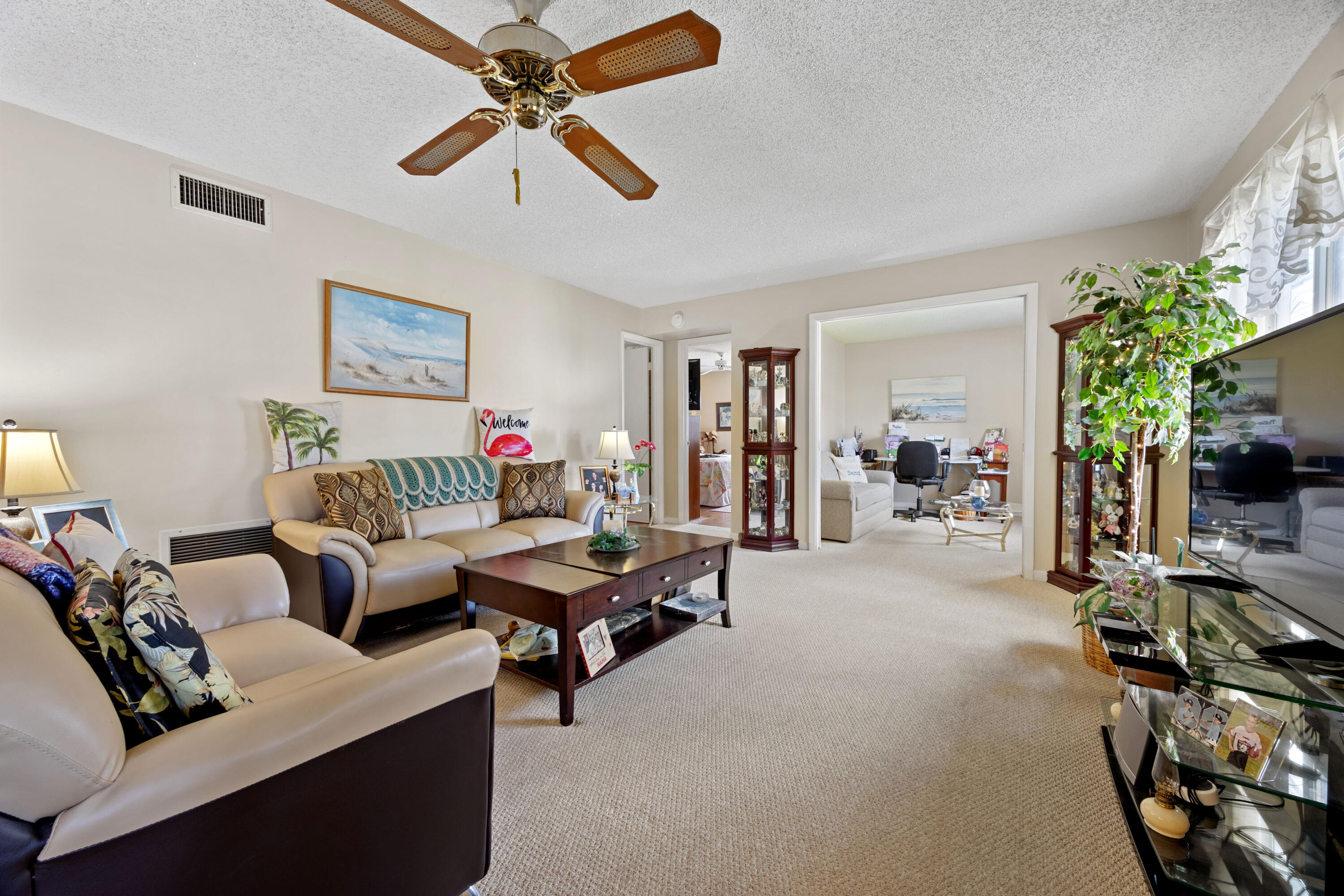 306 Pine Ridge Circle, Unit B2 Greenacres, FL 33463 - Photo 4 of 15 a living room with furniture and a flat screen tv