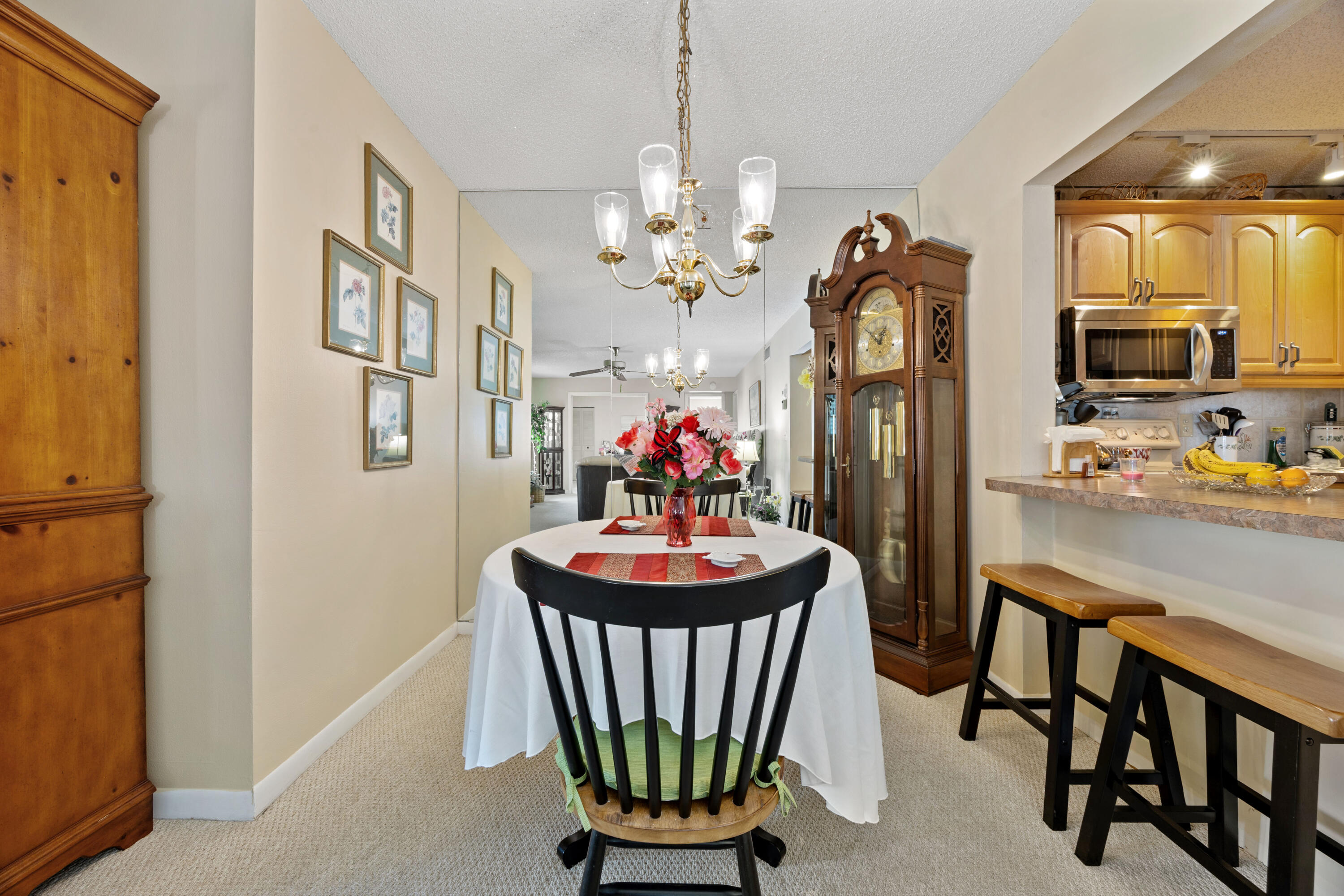 306 Pine Ridge Circle, Unit B2 Greenacres, FL 33463 - Photo 6 of 15 a dining room with furniture a livingroom and chandelier