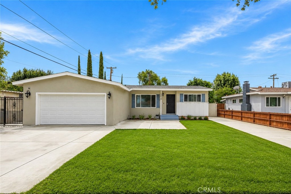 10028 Primrose Drive Riverside, CA 92503 - Photo 3 of 19 a front view of a house with a yard and garage