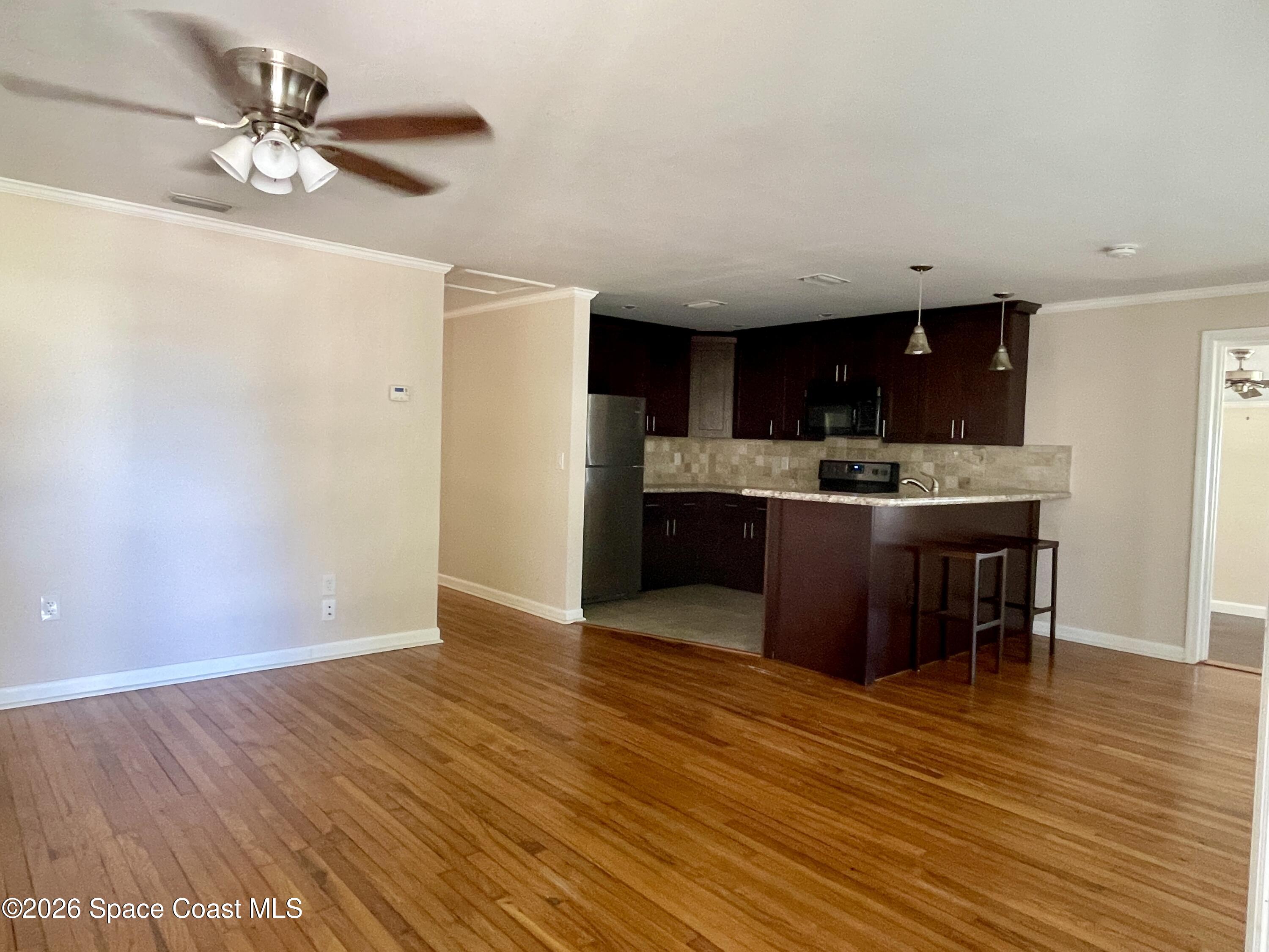 7260 Blue Shore Road Grant, FL 32949 - Photo 4 of 23 Living room towards kitchen
