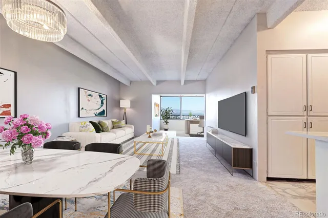 a living room with furniture a flat screen tv and a large window