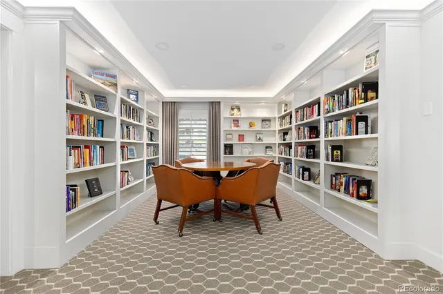 a living room with furniture a rug and kitchen view